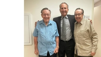 twin brothers smiling with doctor