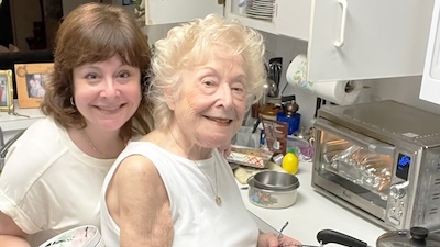 two women smiling in kitchent