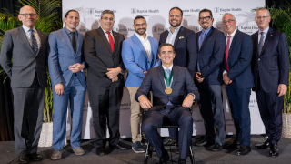 Dr De Los Rios La Rosa sitting with award