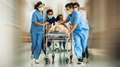 physicians and nurses rushing patient to emergency care